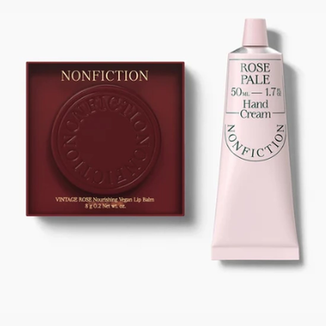 Vintage Rose balm in its burgundy case beside a pale pink Rose Pale hand cream tube.