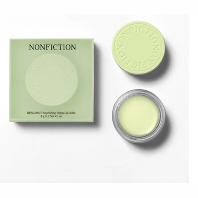 Bergamot nourishing lip balm in a soft green case with an embossed lid, shown beside the open balm.