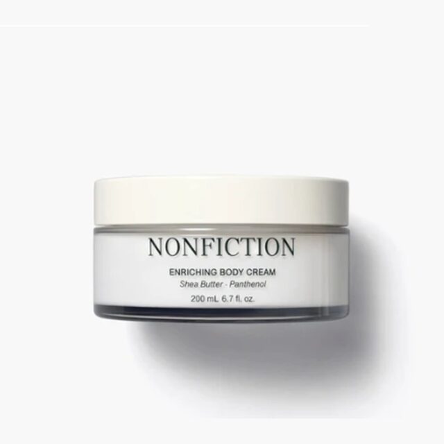 NONFICTION Enriching Body Cream in a wide glass jar with a cream lid.