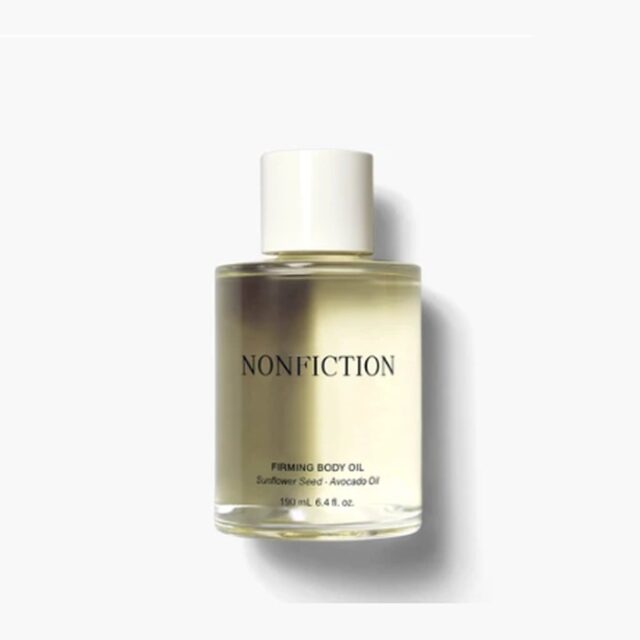 NONFICTION Firming Body Oil in a glass bottle with a cream cap.